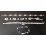 FOUR SILVER BRACELETS comprising a Charles Rennie Mackintosh style blue topaz set bracelet, a