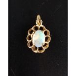 PRETTY OPAL PENDANT the oval cabochon opal in pierced nine carat gold mount