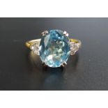 BLUE TOPAZ AND DIAMOND RING the central oval cut blue topaz approximately 4cts, flanked by three