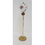 BRASS STANDARD LAMP in the form of an Edwardian oil lamp, raised on a circular base with a four