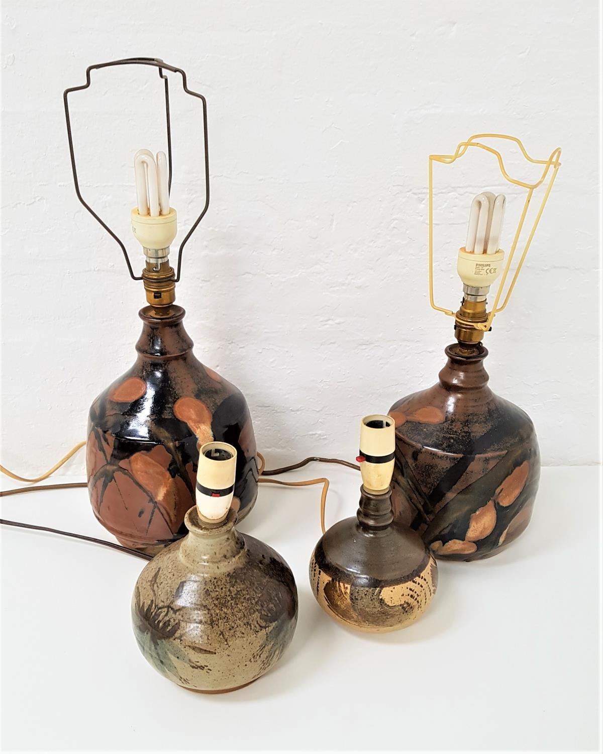 PAIR OF DRYMEN STUDIO POTTERY LAMPS of bulbous form and decorated with brown, black and green glaze,
