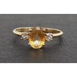 CITRINE AND WHITE SAPPHIRE THREE STONE RING the central oval cut citrine approximately 1.1cts