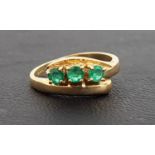 EMERALD THREE STONE RING on nine carat gold shank with twist deign setting, ring size N and