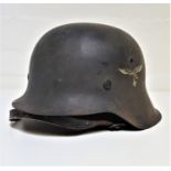 GERMAN WWII HELMET with original transfer of the eagle carrying the swastika to one side, with