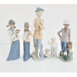 NAO FIGURINE of a young boy by a tree stump with his dog, 23cm high, two Casades figurines of a