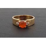 FIRE OPAL AND DIAMOND THREE STONE RING the central round cut fire opal flanked by small diamonds, on