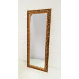 GILT FRAME OBLONG WALL MIRROR with an ornate frame and a plain plate, 101cm high