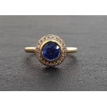 IMPRESSIVE SAPPHIRE AND DIAMOND CLUSTER RING the central bezel set round cut sapphire