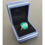 LARGE EMERALD SET RING the oval cut emerald measuring approximately 18.7mm x 16.1mm x 9.45mm,