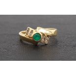 EMERALD AND CLEAR GEM SET CLUSTER RING the central round cut emerald flanked by small clear