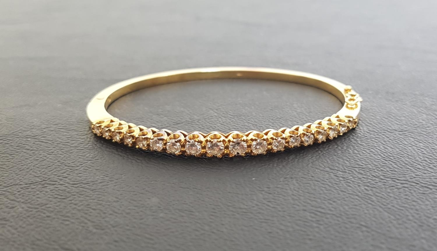 DIAMOND SET EIGHTEEN CARAT GOLD BANGLE the hinged bangles set with graduated round brilliant cut