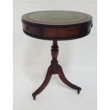 MAHOGANY DRUM TOP OCCASIONAL TABLE with an inset green leather top above three frieze drawers,