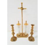 PAIR OF BRASS KNOPPED CANDLESTICKS raised on square basses, one with an ejector, 30cm high, together