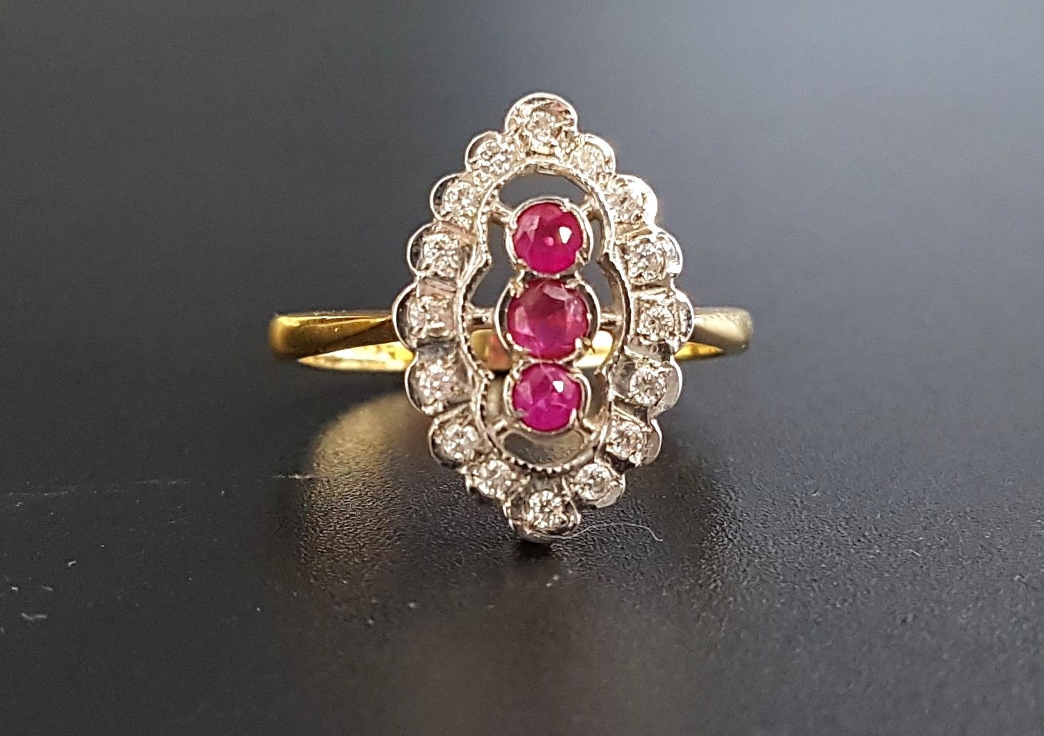 RUBY AND DIAMOND PLAQUE RING the central three rubies in vertical setting totaling approximately 0.