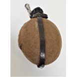 GERMAN WWII WATER BOTTLE of oval form in aluminium with a felt cover with stud fastening and leather