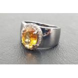 CITRINE AND DIAMOND CLUSTER RING the central oval cut citrine in rose cut diamond surround, on