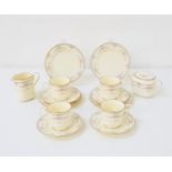 NORITAKE TEA SERVICE with a cream ground and floral motifs, comprising cups and saucers, side