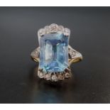 IMPRESSIVE BLUE TOPAZ AND DIAMOND COCKTAIL RING the large emerald cut blue topaz measuring