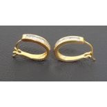 PAIR OF DIAMOND SET HOOP STYLE EARRINGS each with channel set baguette cut diamonds to one side,