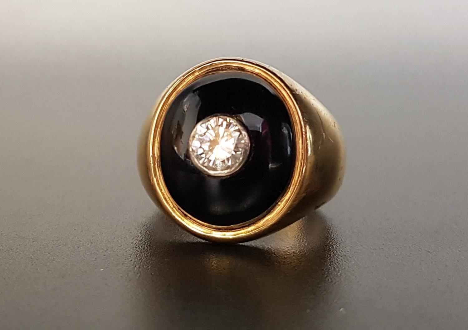 DIAMOND AND ONYX SIGNET RING the central bezel set round brilliant cut diamond approximately 0. - Image 2 of 3