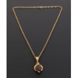 GARNET SET NINE CARAT GOLD PENDANT the garnet in twist setting, approximately 2cm high including