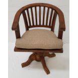 TEAK CAPTAIN'S STYLE SWIVEL CHAIR with a hoop back above a solid seat with a shaped cushion,