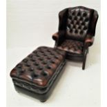 CHESTERFIELD WING ARMCHAIR in brown leather with a button back and seat, the scroll arms with
