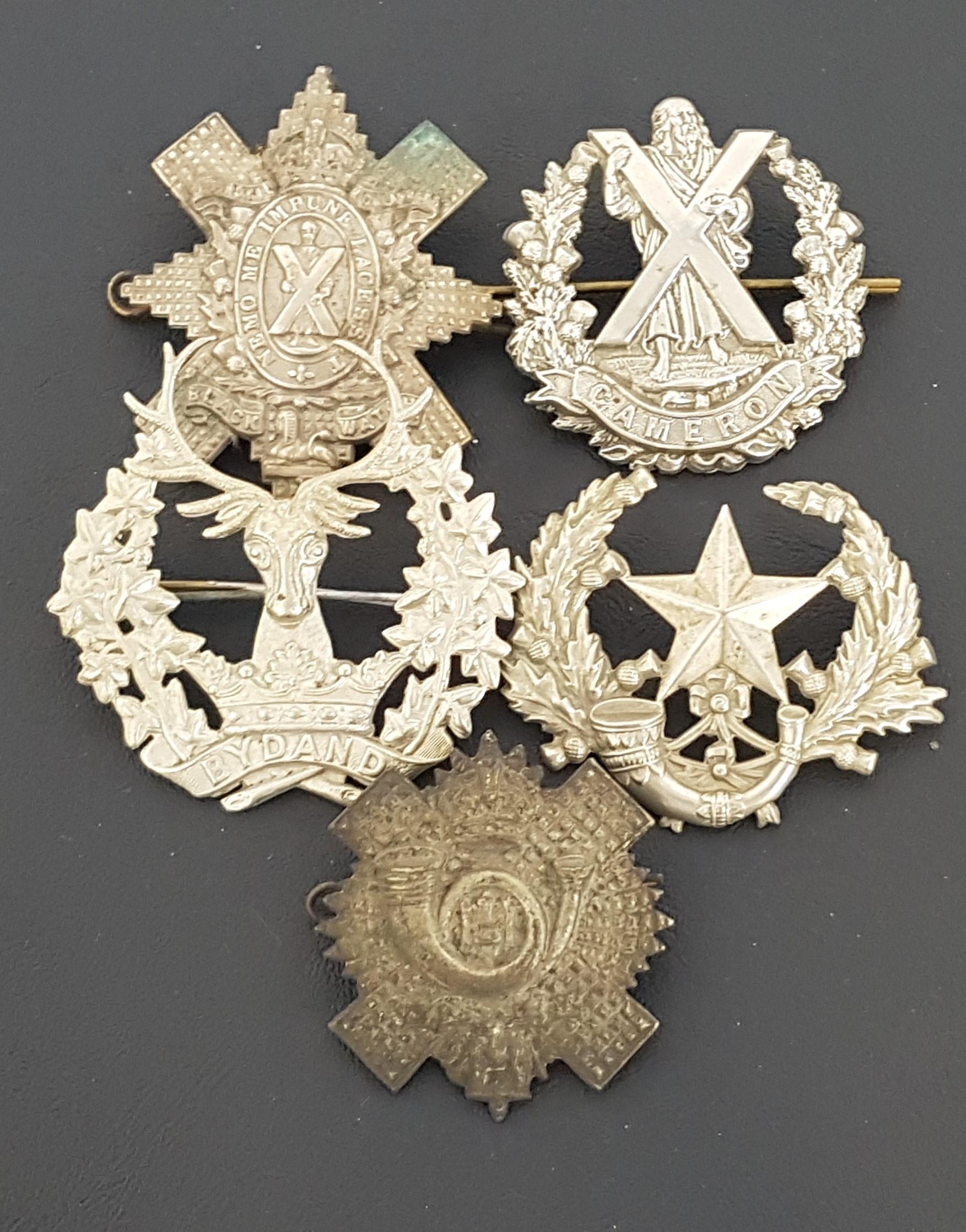 SELECTION OF FIVE METAL MILITARY CAP BADGES including the Cameronians, Cameron Highlanders, Highland