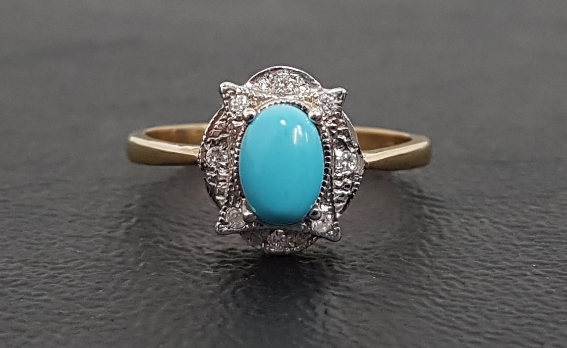 TURQUOISE AND DIAMOND CLUSTER RING the central oval cabochon turquoise in shaped diamond set