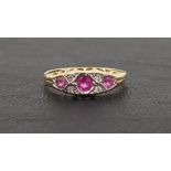 RUBY AND DIAMOND RING the three graduated rubies separated by small diamonds, on eighteen carat gold