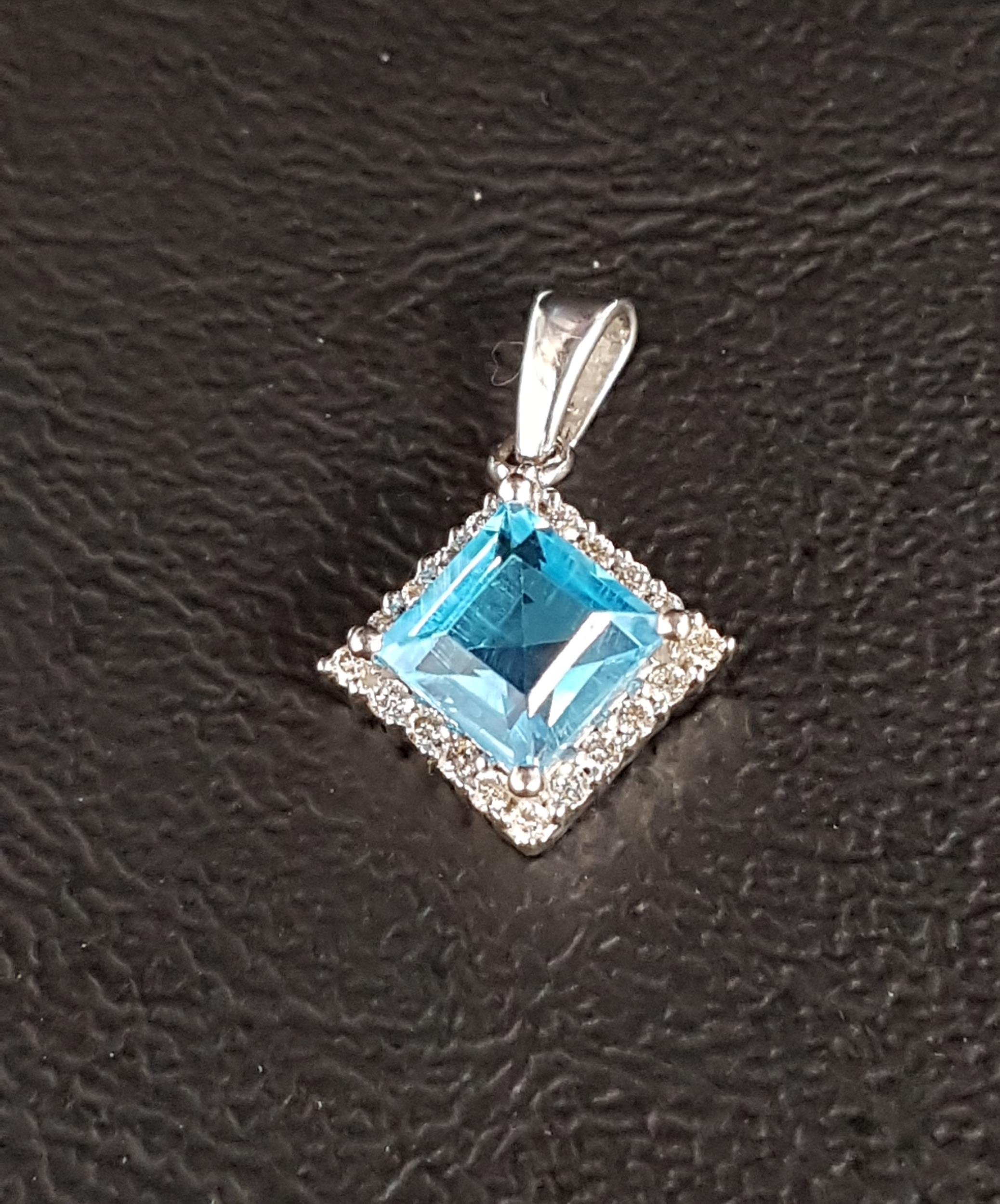 BLUE TOPAZ AND DIAMOND CLUSTER PENDANT the central square cut blue topaz in diamond surround