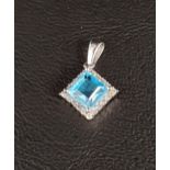 BLUE TOPAZ AND DIAMOND CLUSTER PENDANT the central square cut blue topaz in diamond surround