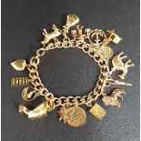 GOLD CHARM BRACELET the nine carat gold fancy curb link bracelet with a selection of nine,