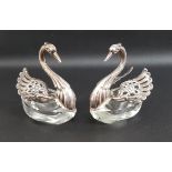 PAIR OF SILVER SWAN SALTS each swan with silver heads and pierced wings, with glass bases, both