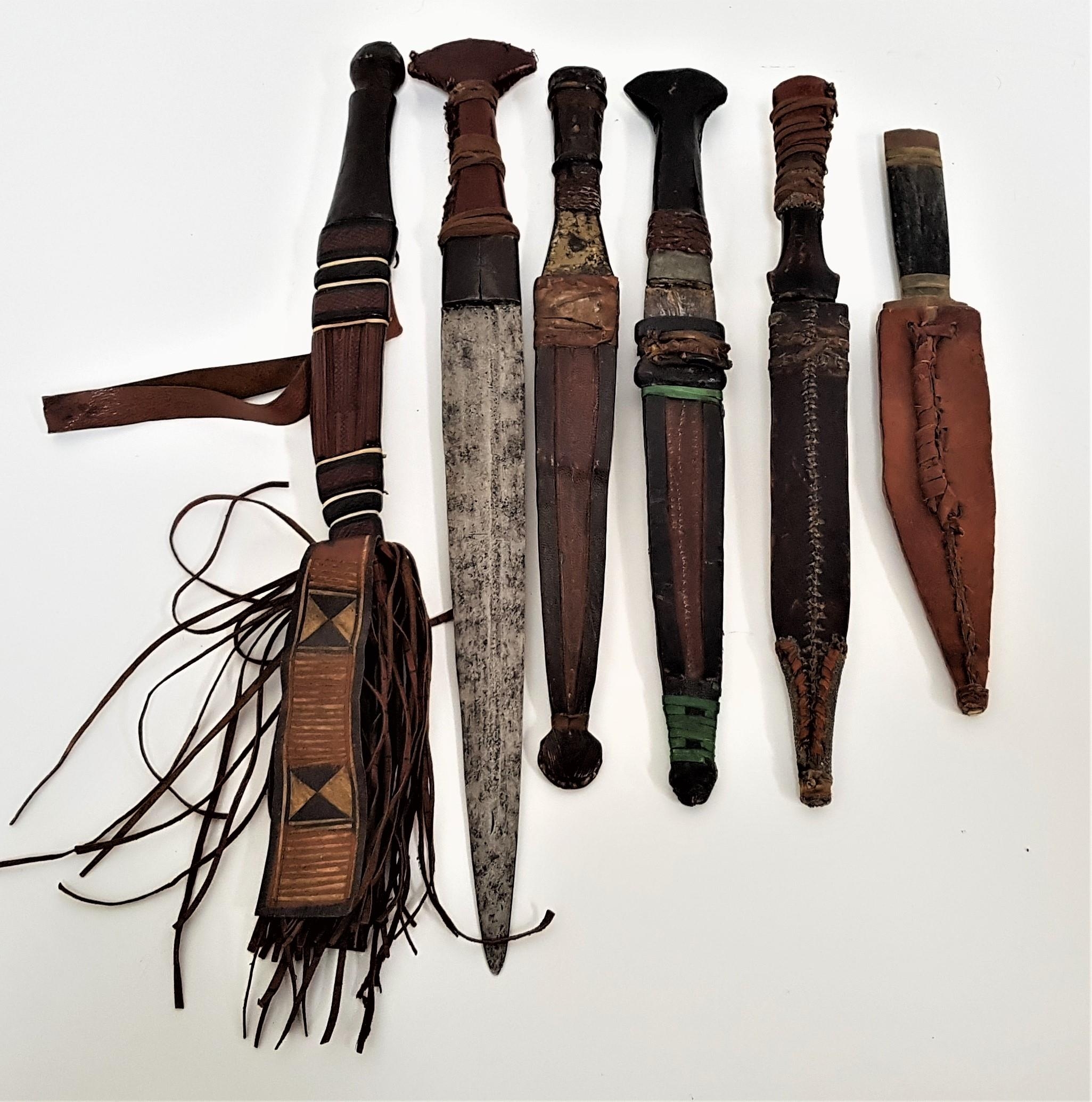 SIX AFRICAN DAGGERS five with double edged blades, all with leather wrapped handles, five with - Image 2 of 2