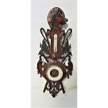 CARVED AND STAINED PINE ANEROID BAROMETER surmounted with a horse head and horseshoe with a