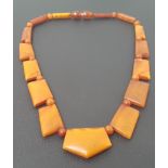 ART DECO AMBER BEAD NECKLACE with graduated shaped links and screw fastening, approximately 19.6