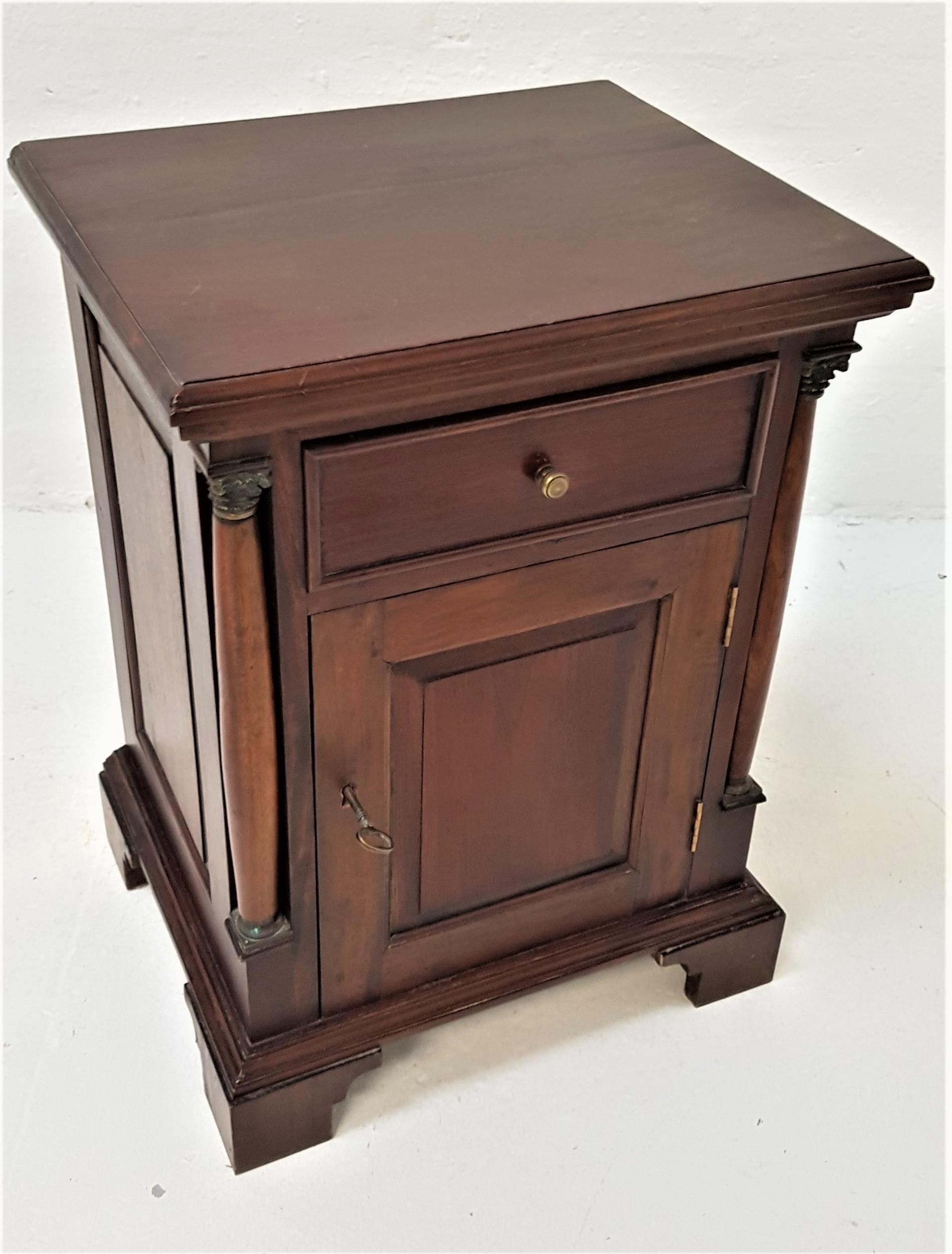 TEAK SIDE CABINET with a moulded top above a paneled frieze drawer with a paneled cupboard door