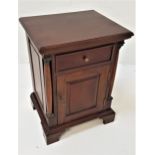 TEAK SIDE CABINET with a moulded top above a paneled frieze drawer with a paneled cupboard door