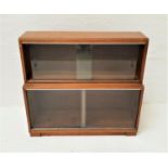 MINTY TEAK BOOKCASE with a moulded top above a pair of glass sliding doors above another pair of