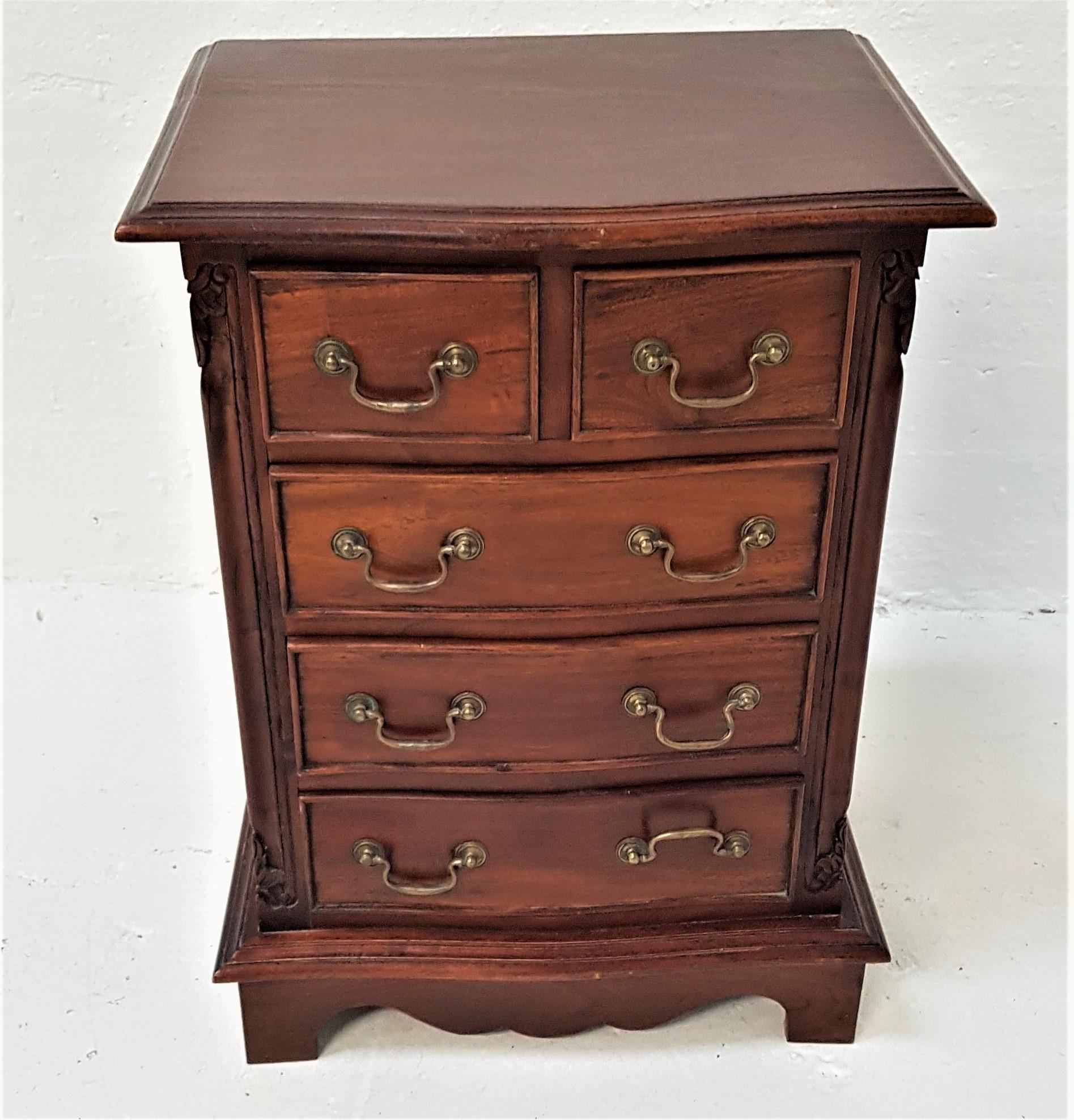 SMALL TEAK CHEST with a moulded serpentine top above two short and three long cockbeaded drawers,