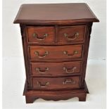 SMALL TEAK CHEST with a moulded serpentine top above two short and three long cockbeaded drawers,