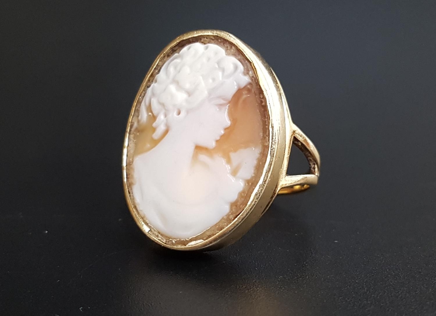 LARGE CAMEO DRESS RING the oval cameo depicting a female bust in profile, on nine carat gold