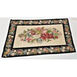 KAFFE FASSETT EHRMAN TAPESTRY RUG with a central cream ground with floral motifs, encased by a black