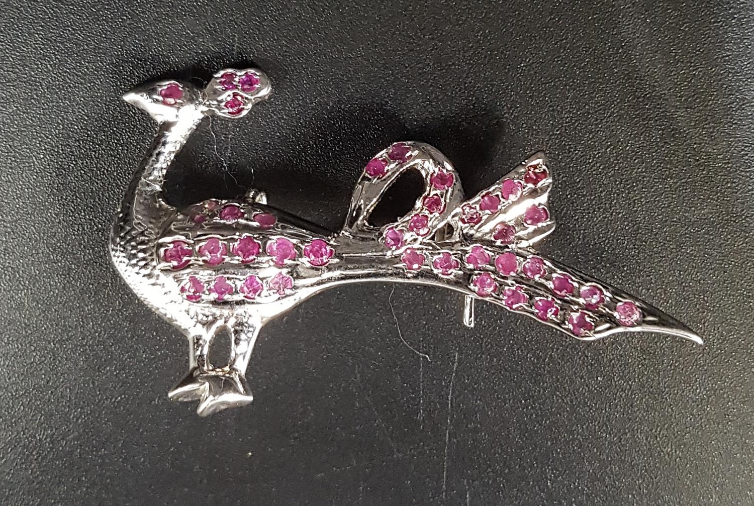 RUBY SET PEACOCK BROOCH in silver, approximately 4.7cm wide