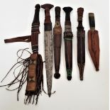 SIX AFRICAN DAGGERS five with double edged blades, all with leather wrapped handles, five with