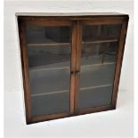 STAINED OAK SIDE CABINET with a pair of glazed doors opening to reveal adjustables shelves, standing