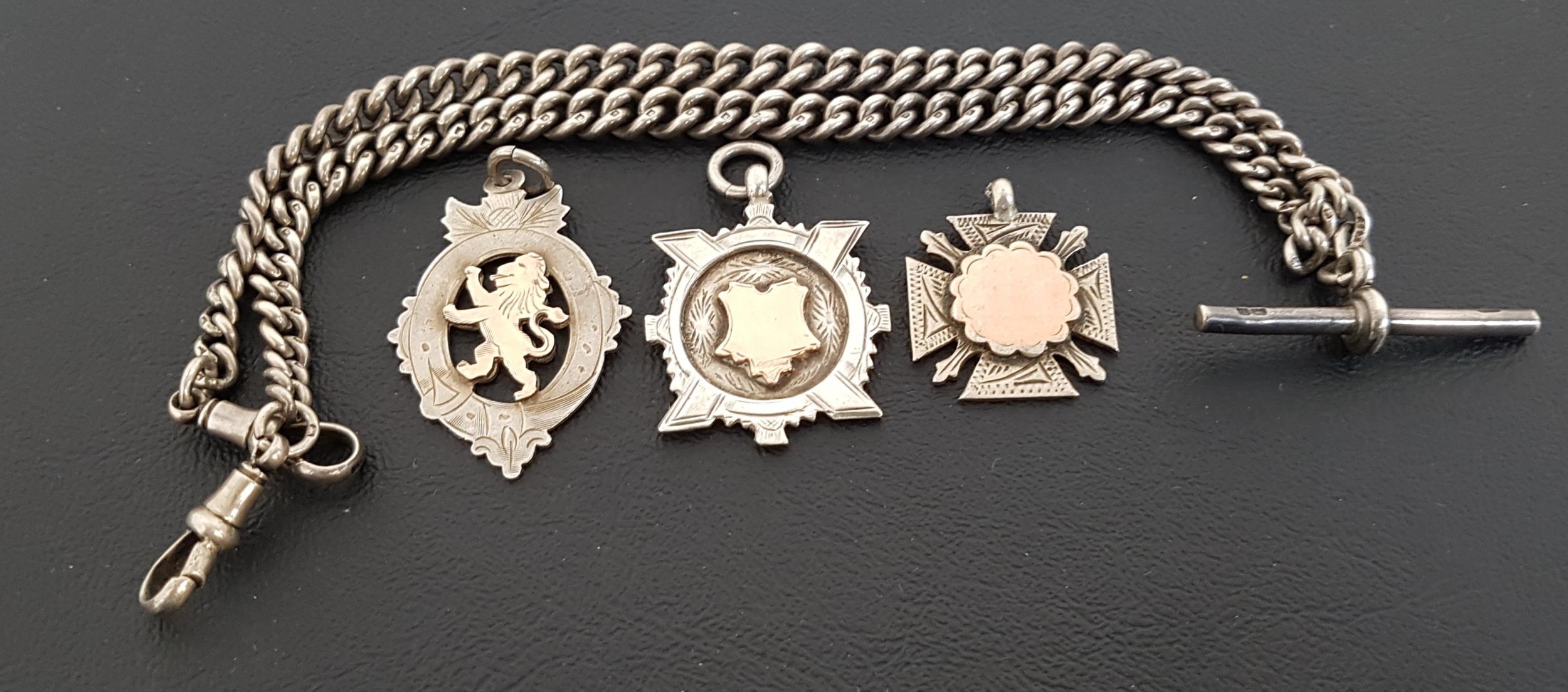 SILVER DOUBLE ALBERT CHAIN with T-bar, together with three silver medal fobs, all with gold