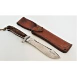 PUMA AUTOMESSER BOWIE KNIFE with a shaped 15.5cm long blade with saw teeth, the wood handle with