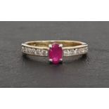 RUBY AND DIAMOND RING the central oval cut ruby approximately 0.3cts flanked by channel set diamonds